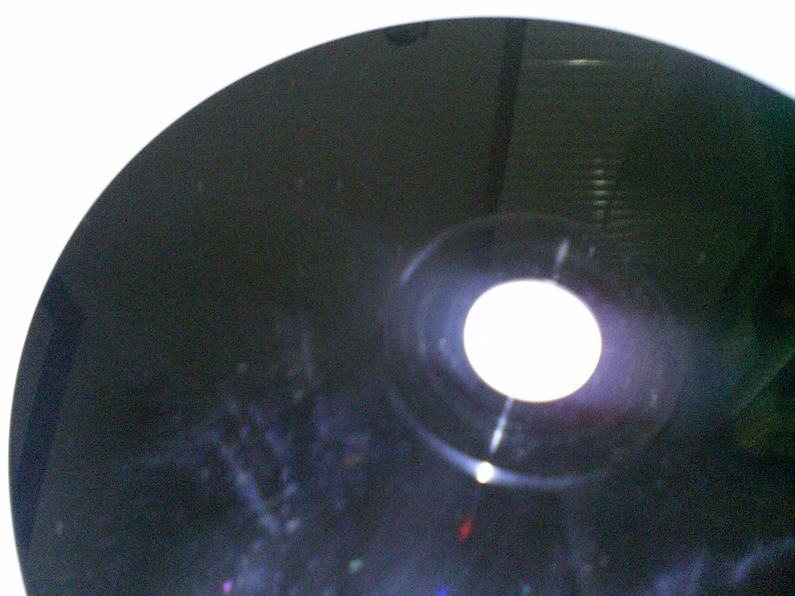A PlayStation CD-ROM with its dark data side visible