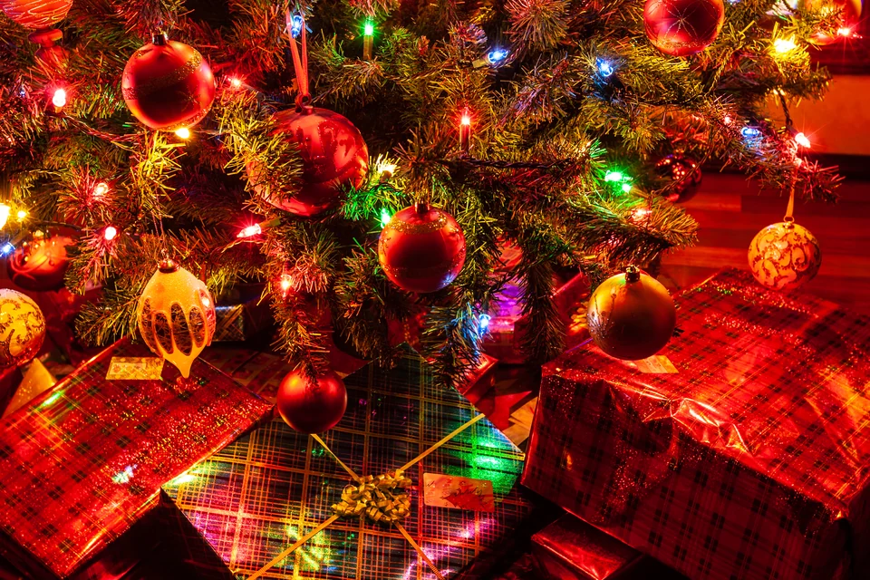 Christmas tree and wrapped presents in warm evening light